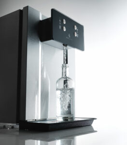 Eauvation Acqua 80 Wasserspender füllt eine Glasflasche mit Sprudelwasser